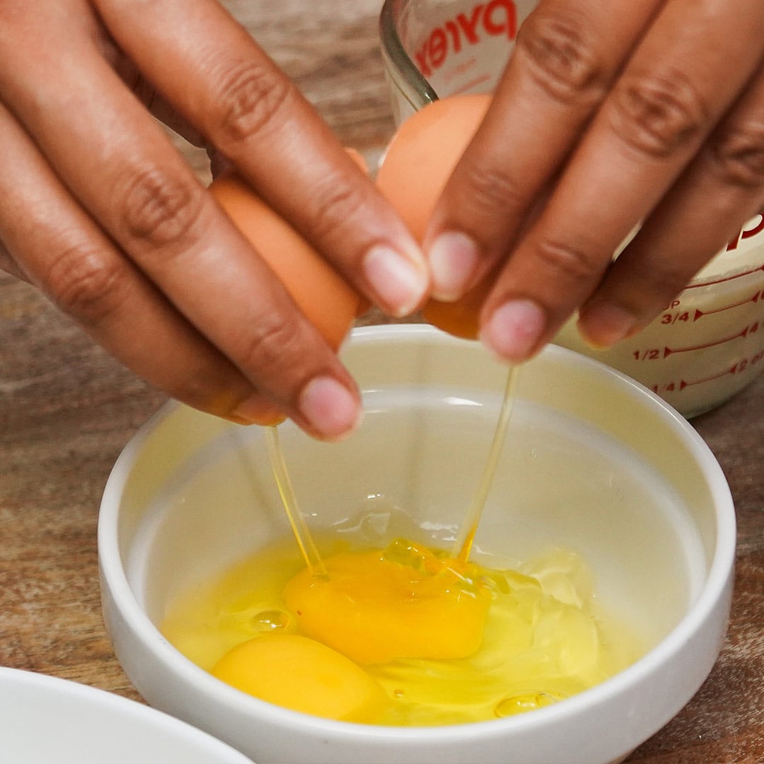 Crack eggs into a separate bowl, one at a time.